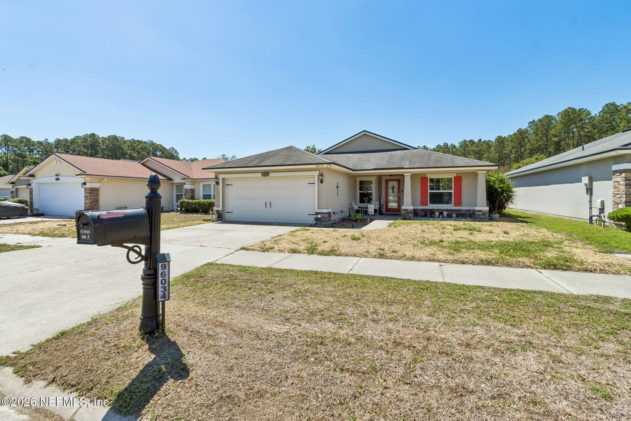 96034 Bass Lane Yulee, FL 32097 - Photo 2 of 50 a view of a house with a yard