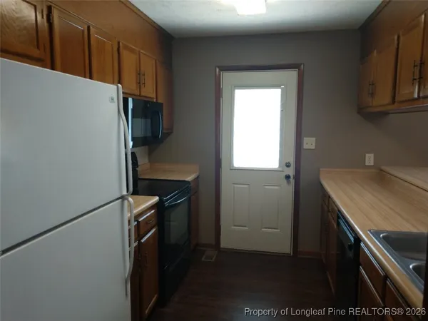 a view of backyard of house with green space