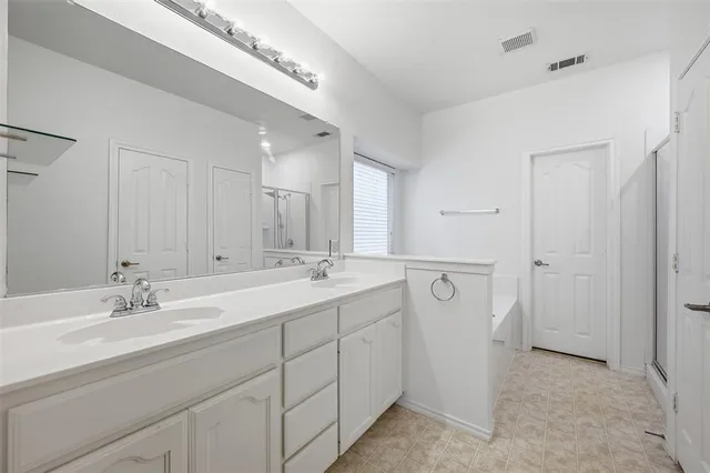 a bathroom with a double vanity sink and mirror