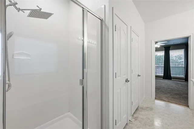 a bathroom with a shower and a glass door