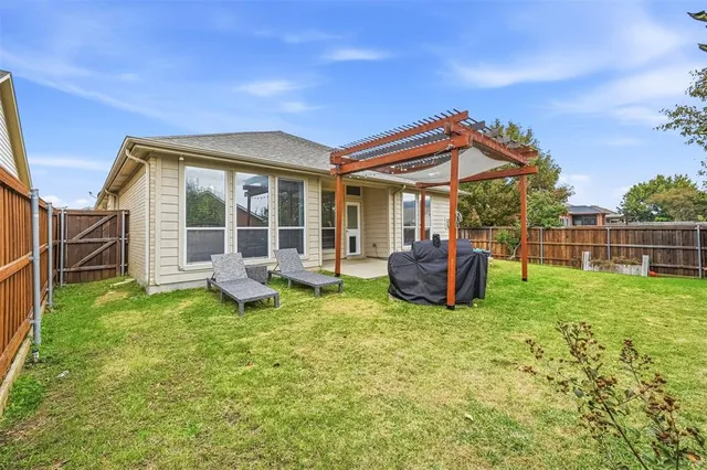 a view of a house with backyard sitting area and garden
