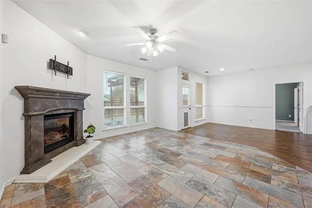a view of empty room with wooden floor and fireplace