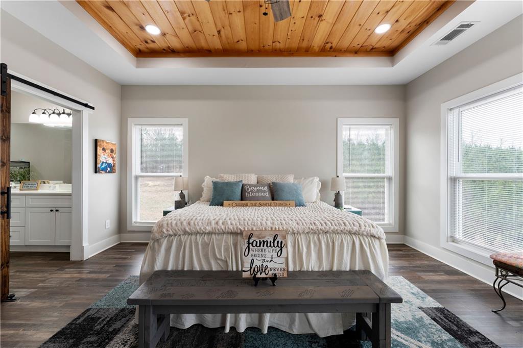 610 Cedar Creek Road Cartersville, GA 30121 - Photo 35 of 75 a bedroom with a bed and wooden floor