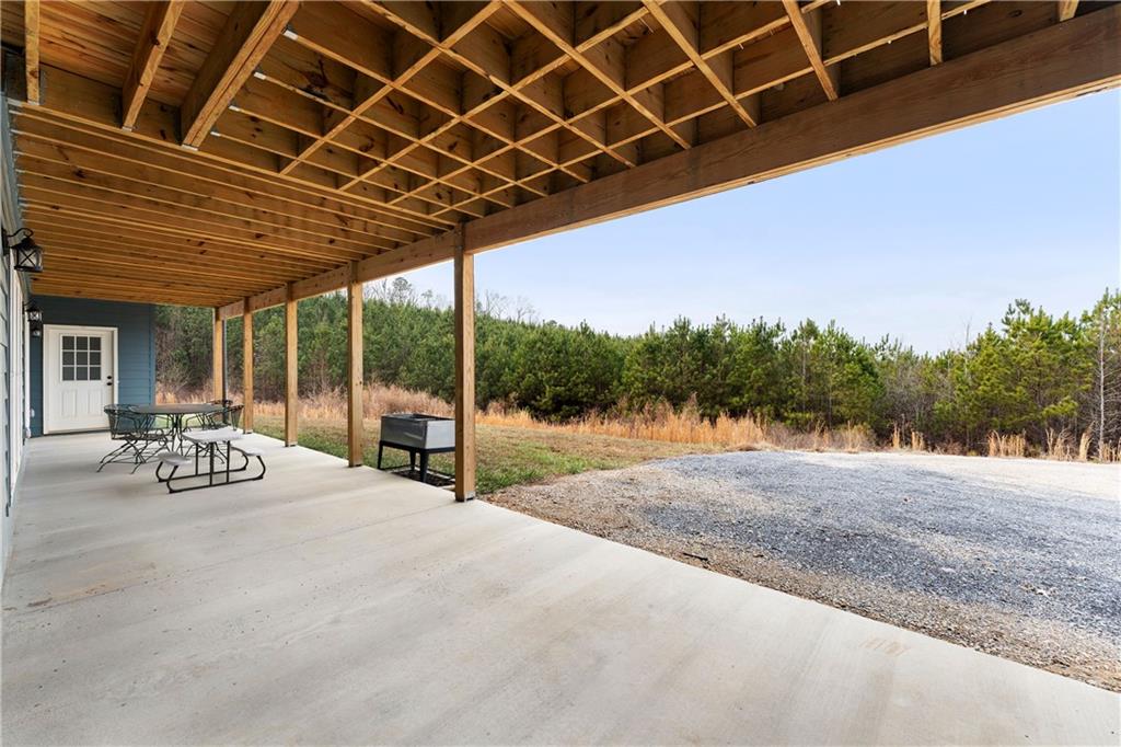 610 Cedar Creek Road Cartersville, GA 30121 - Photo 74 of 75 a view of a backyard of a house with porch and outdoor seating