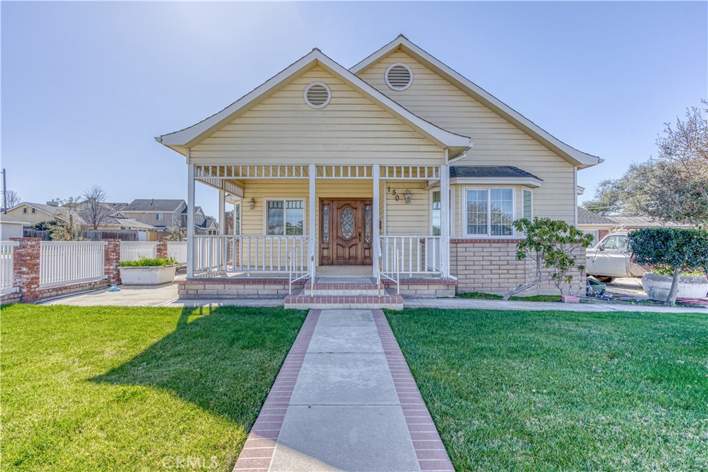 a front view of a house with a yard and porch