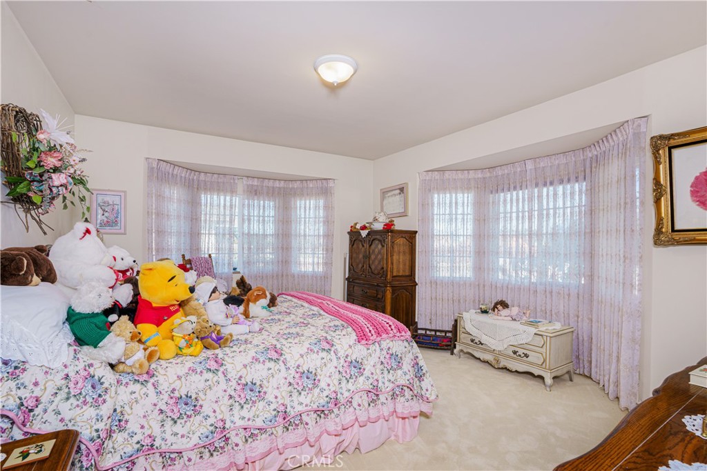 150 Pinal Avenue Santa Maria, CA 93455 - Photo 23 of 36 a bedroom with a bed and large windows