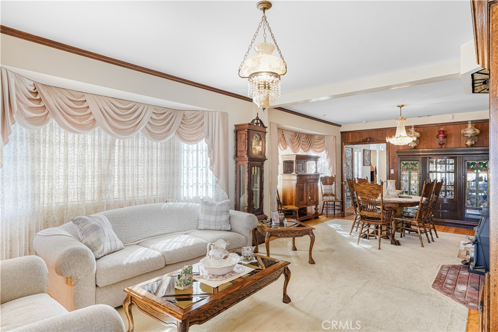 150 Pinal Avenue Santa Maria, CA 93455 - Photo 9 of 36 a living room with furniture windows and a chandelier