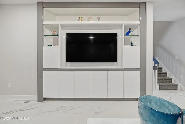 a living room with furniture cabinets and window