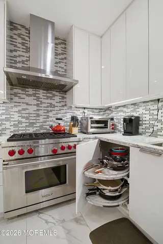 a kitchen with granite countertop a sink cabinets and stainless steel appliances