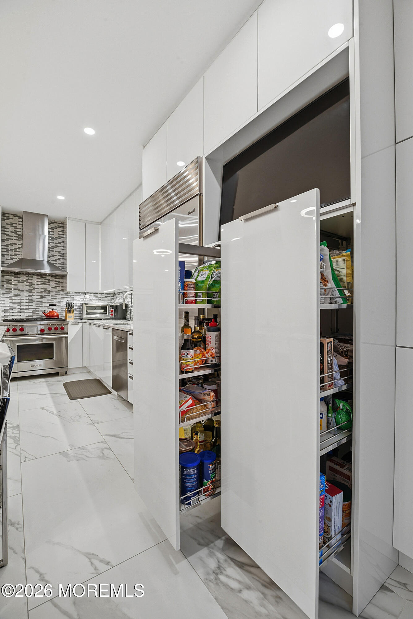 17 Riviera Drive Long Branch, NJ 07740 - Photo 25 of 46 a kitchen with refrigerator and cabinets