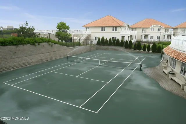 a view of an house with backyard space and balcony