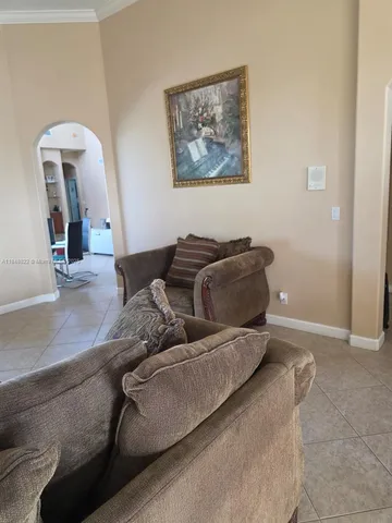 a view of a patio with table and chairs potted plants and a large tree