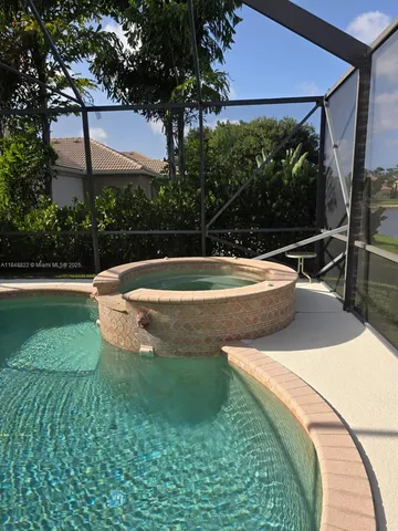 a bathroom with a glass shower door and a sink