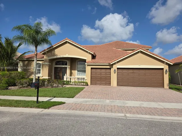 a front view of a house with a yard and garage