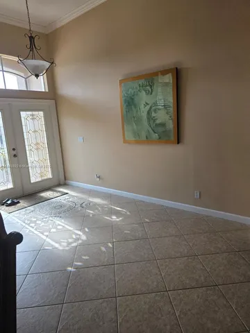 a view of a livingroom with kitchen furniture and window