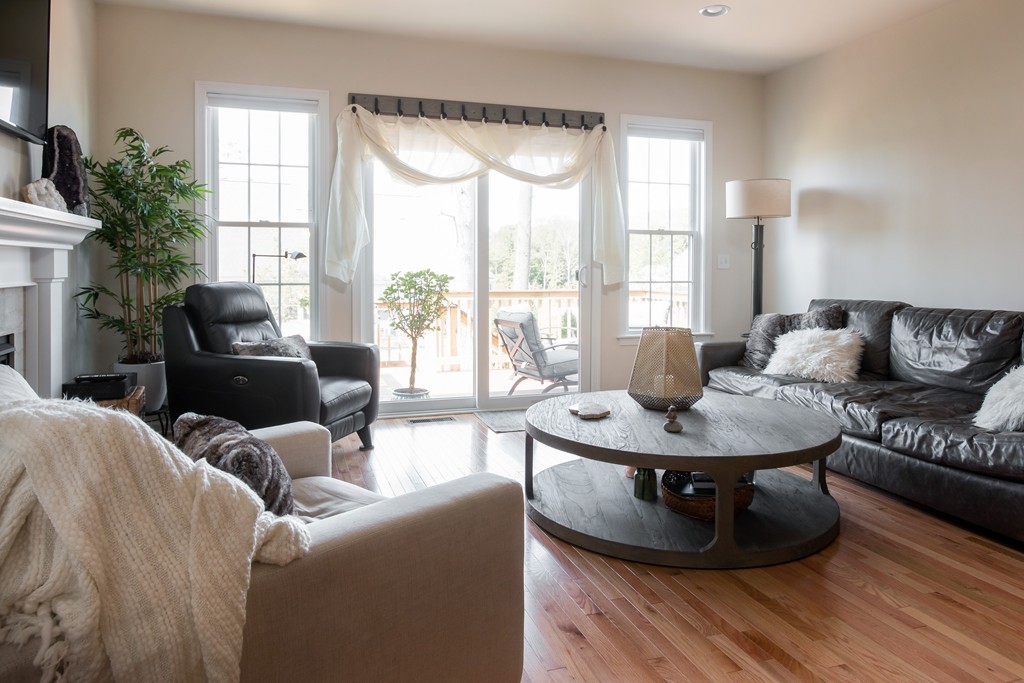 81 Monroe Drive, Unit 16 Holliston, MA 01746 - Photo 20 of 30 a living room with furniture and a large window