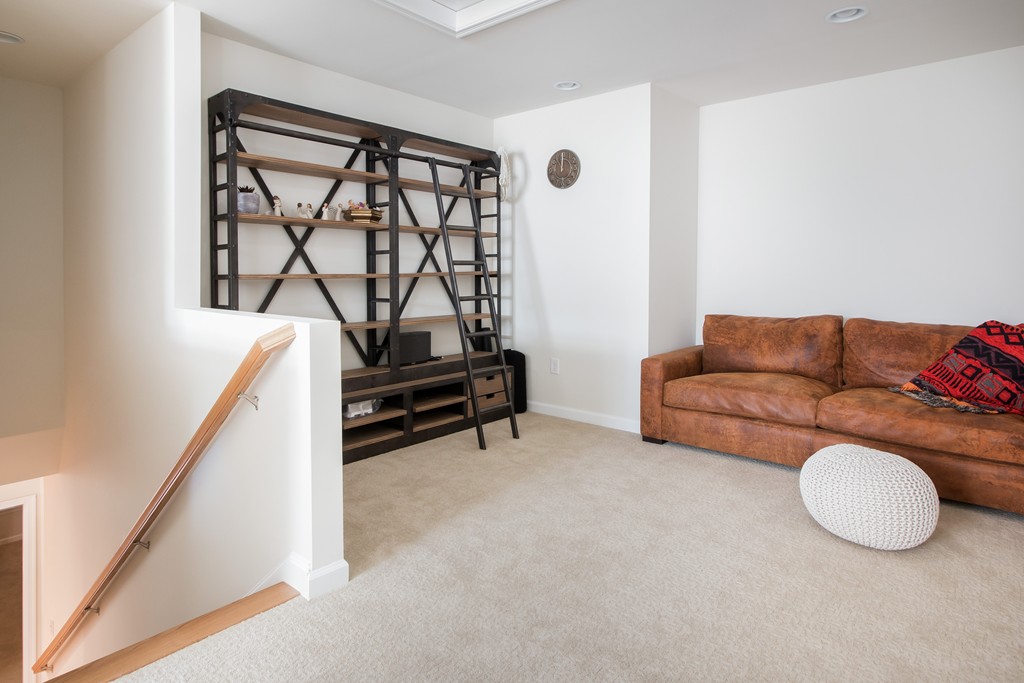 81 Monroe Drive, Unit 16 Holliston, MA 01746 - Photo 25 of 30 a living room with furniture and a window