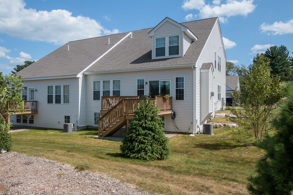 81 Monroe Drive, Unit 16 Holliston, MA 01746 - Photo 4 of 30 a view of a house with backyard