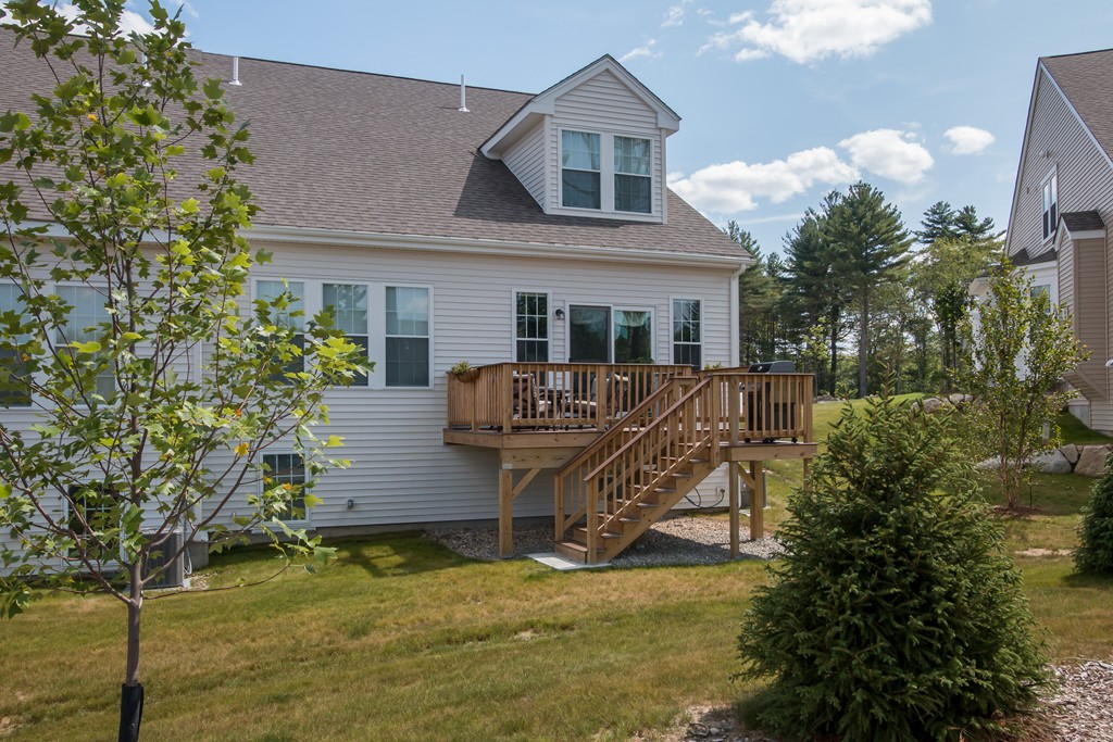 81 Monroe Drive, Unit 16 Holliston, MA 01746 - Photo 5 of 30 a view of a house with a yard chairs and a tree