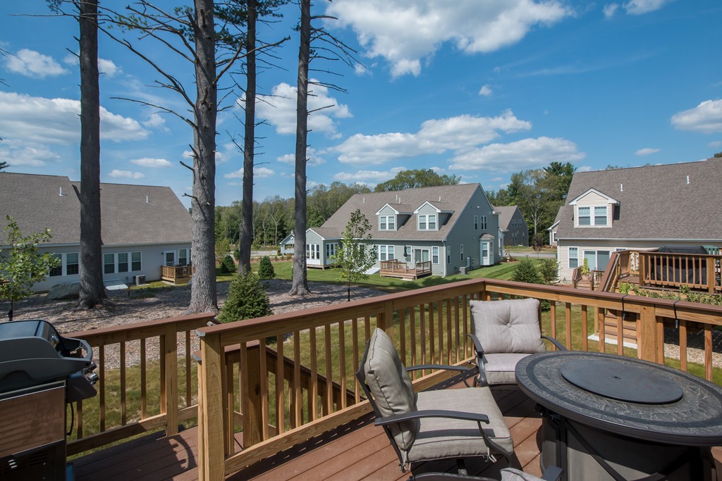 81 Monroe Drive, Unit 16 Holliston, MA 01746 - Photo 6 of 30 a view of a city from a balcony with furniture