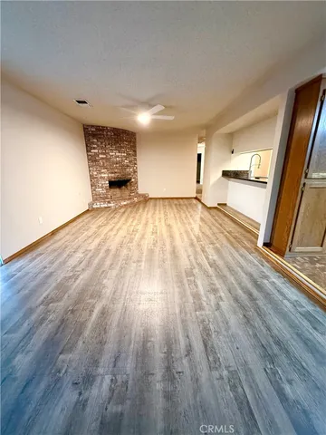 a view of a room with wooden floor and a window