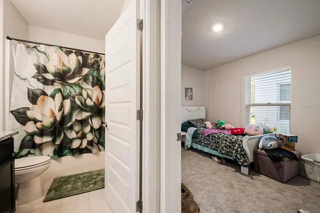 a bedroom with furniture and a window