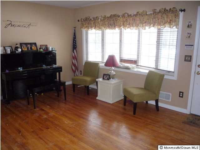 2403 Monmouth Court Point Pleasant, NJ 08742 - Photo 3 of 15 a living room with furniture and a wooden floor