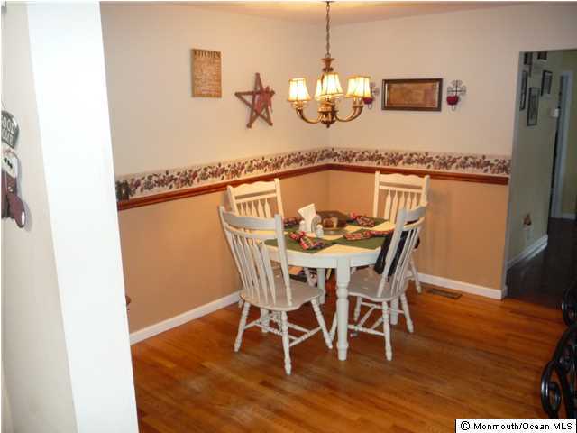 2403 Monmouth Court Point Pleasant, NJ 08742 - Photo 4 of 15 a view of a dining room with furniture and wooden floor