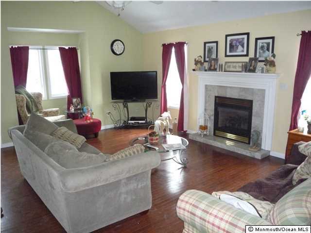 2403 Monmouth Court Point Pleasant, NJ 08742 - Photo 5 of 15 a living room with furniture fireplace and window