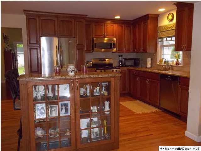 2403 Monmouth Court Point Pleasant, NJ 08742 - Photo 7 of 15 a kitchen with stainless steel appliances granite countertop a refrigerator and a stove top oven