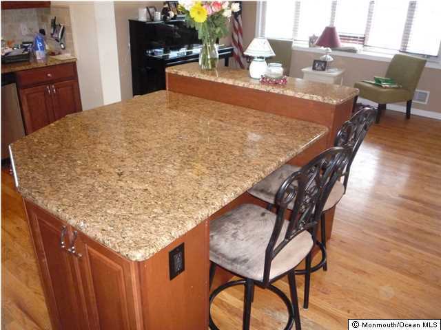 2403 Monmouth Court Point Pleasant, NJ 08742 - Photo 8 of 15 a dining table with chairs and wooden floor