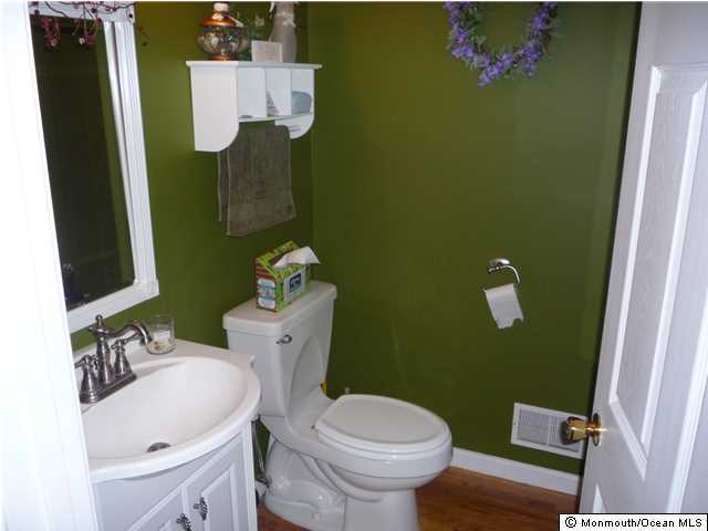 2403 Monmouth Court Point Pleasant, NJ 08742 - Photo 10 of 15 a bathroom with a sink mirror vanity and toilet