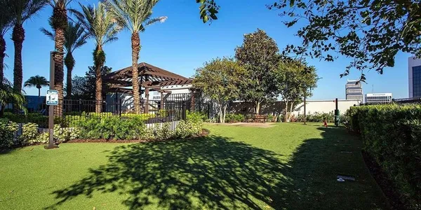 a view of a house with a yard and basketball ground