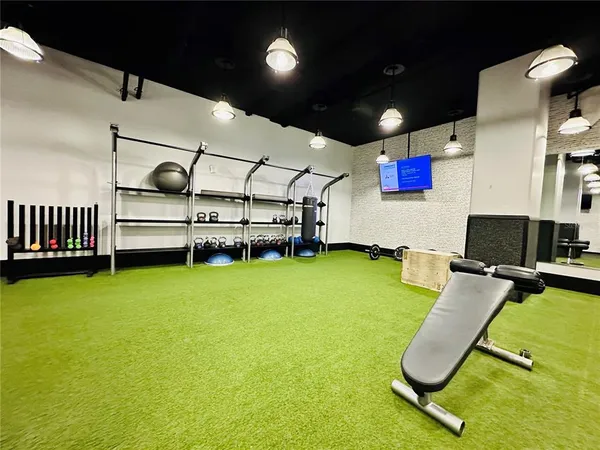 a room with gym equipment and windows