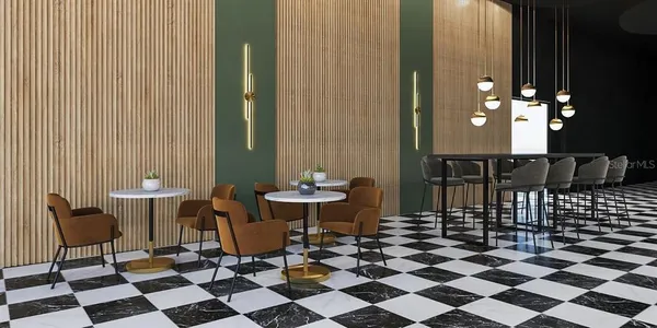 a room with a black white checkered floor with a gaming machine and dining chairs