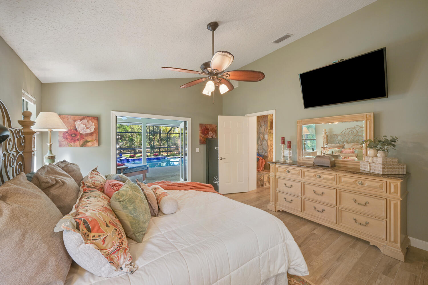 16219 134th Terrace North Jupiter, FL 33478 - Photo 15 of 40 a bedroom with a bed a window and a flat screen television