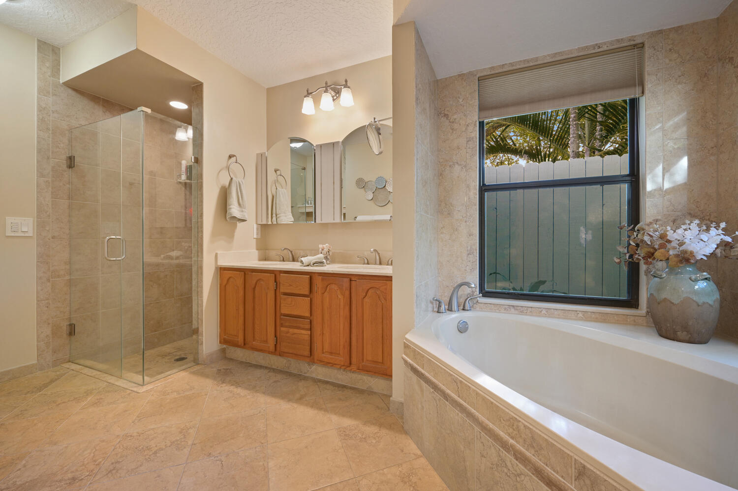 16219 134th Terrace North Jupiter, FL 33478 - Photo 16 of 40 a spacious bathroom with a granite countertop tub sink shower and mirror
