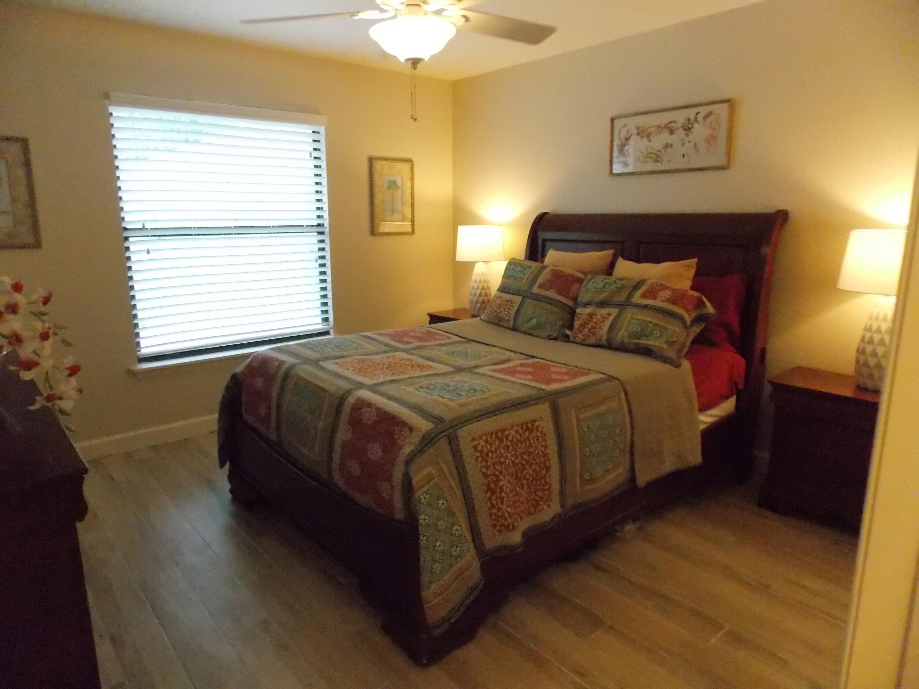 16219 134th Terrace North Jupiter, FL 33478 - Photo 19 of 40 a bedroom with a bed and lamps