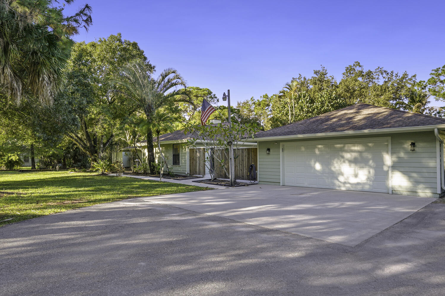 16219 134th Terrace North Jupiter, FL 33478 - Photo 2 of 40 a view of a house with a yard and a garage