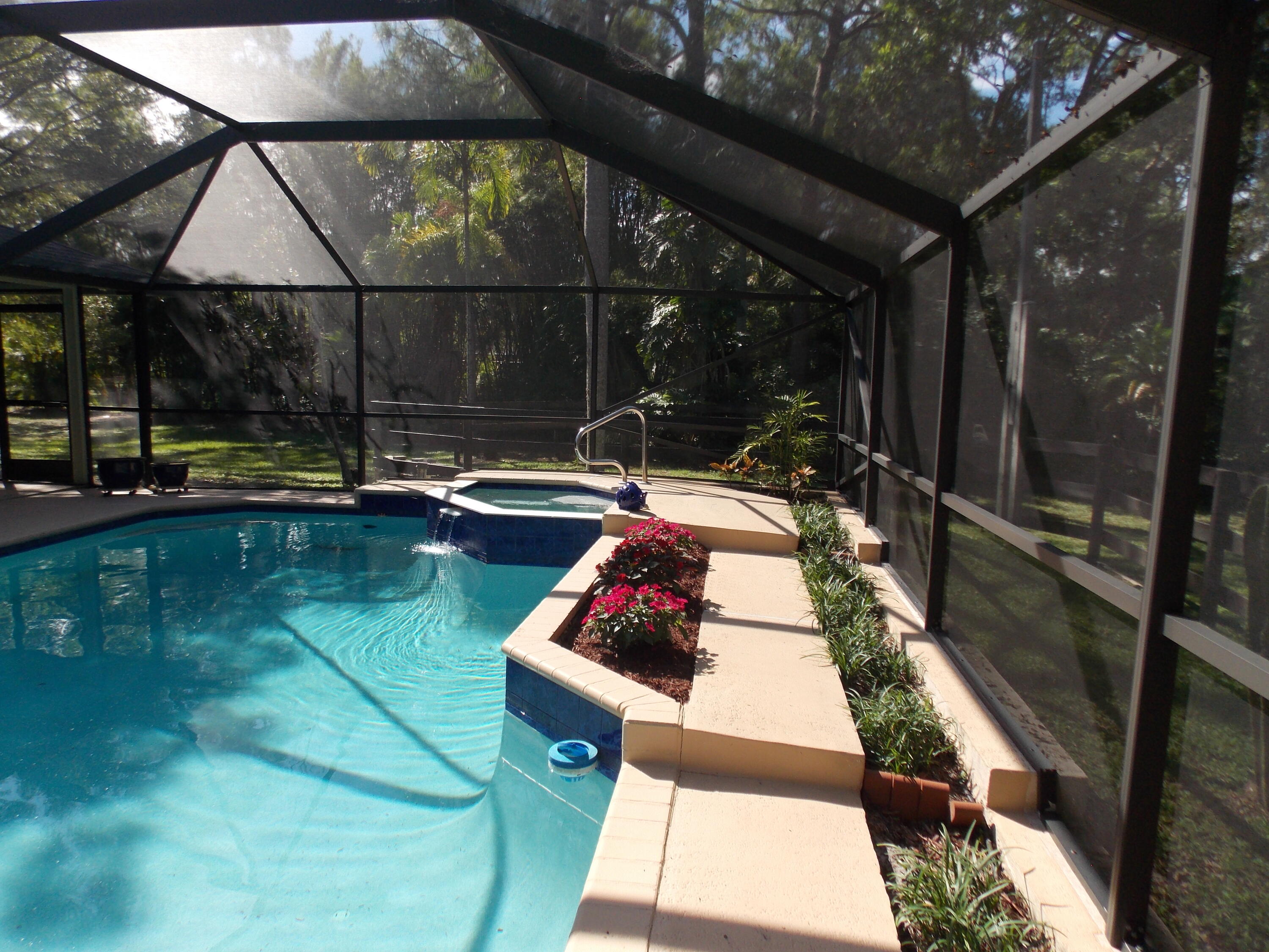 16219 134th Terrace North Jupiter, FL 33478 - Photo 29 of 40 a swimming pool with outdoor seating and yard