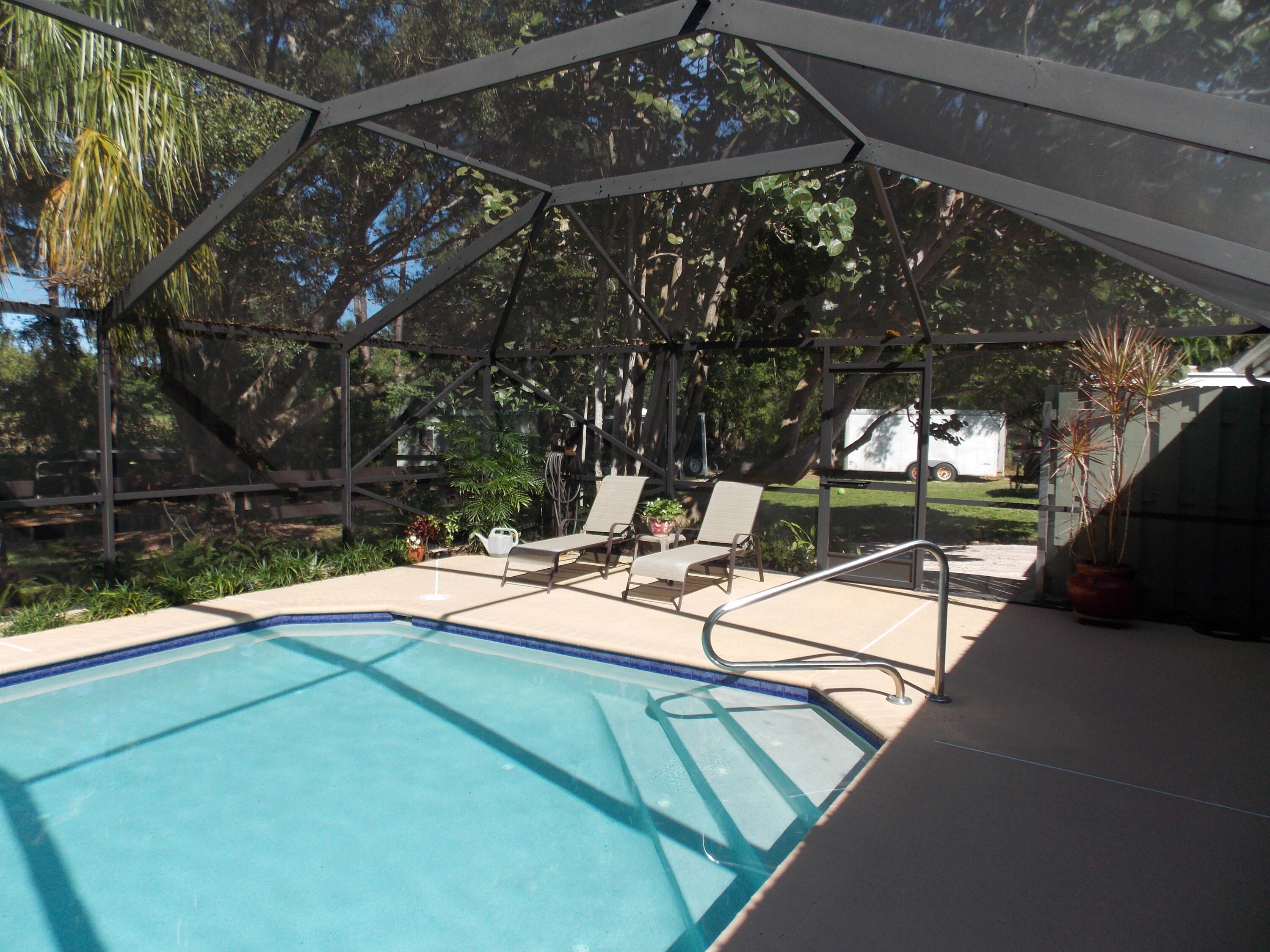 16219 134th Terrace North Jupiter, FL 33478 - Photo 30 of 40 a view of a patio with chairs and a yard