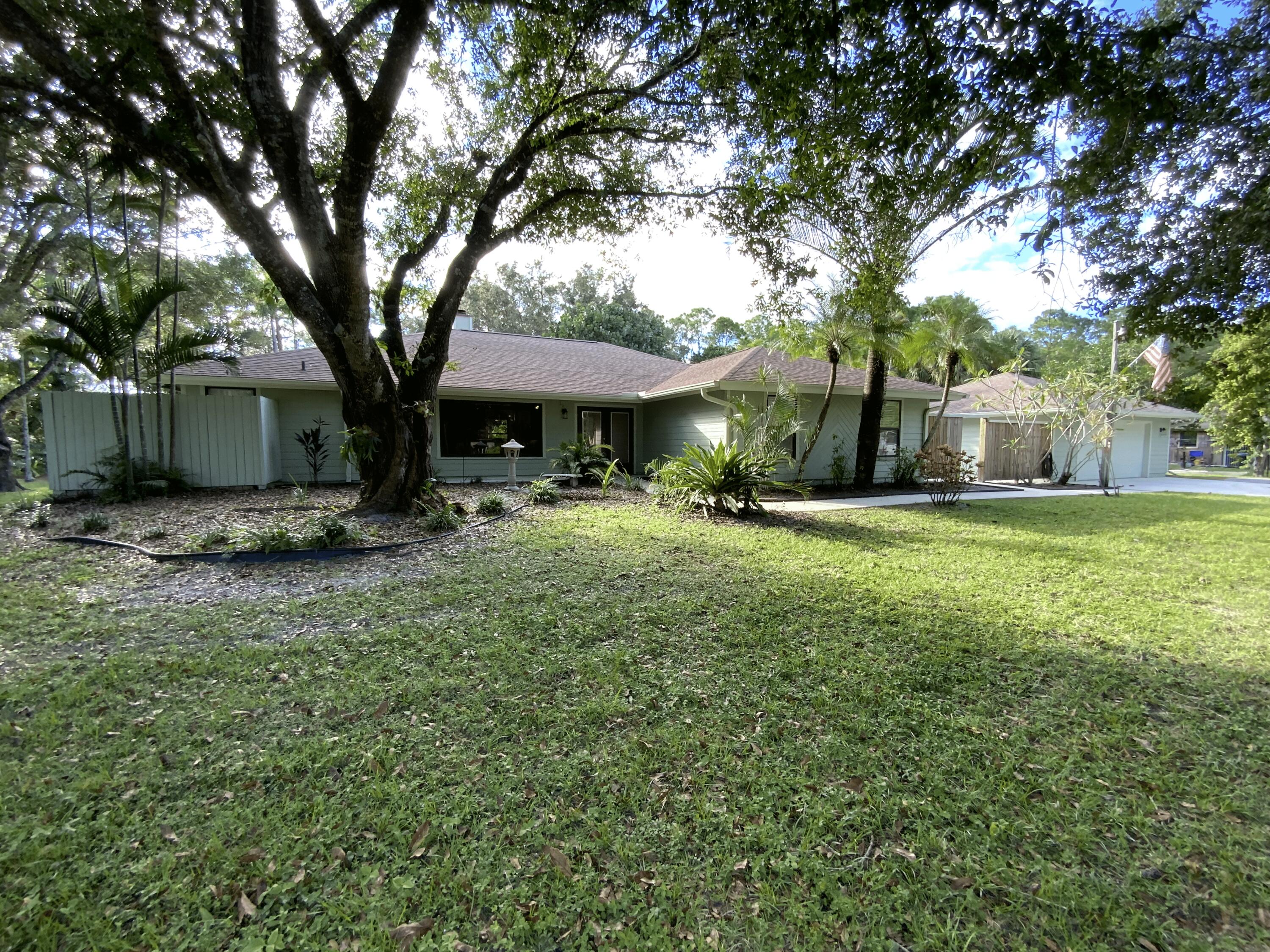 16219 134th Terrace North Jupiter, FL 33478 - Photo 3 of 40 a view of a house with a yard