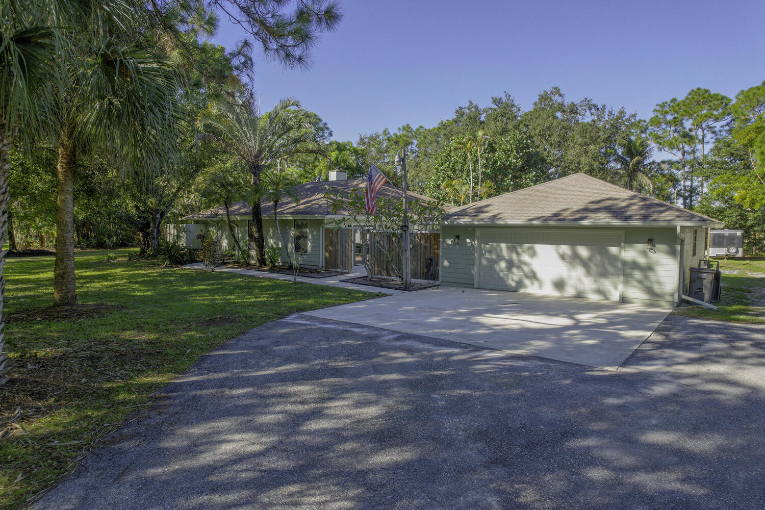 16219 134th Terrace North Jupiter, FL 33478 - Photo 35 of 40 a front view of a house with a yard and garage
