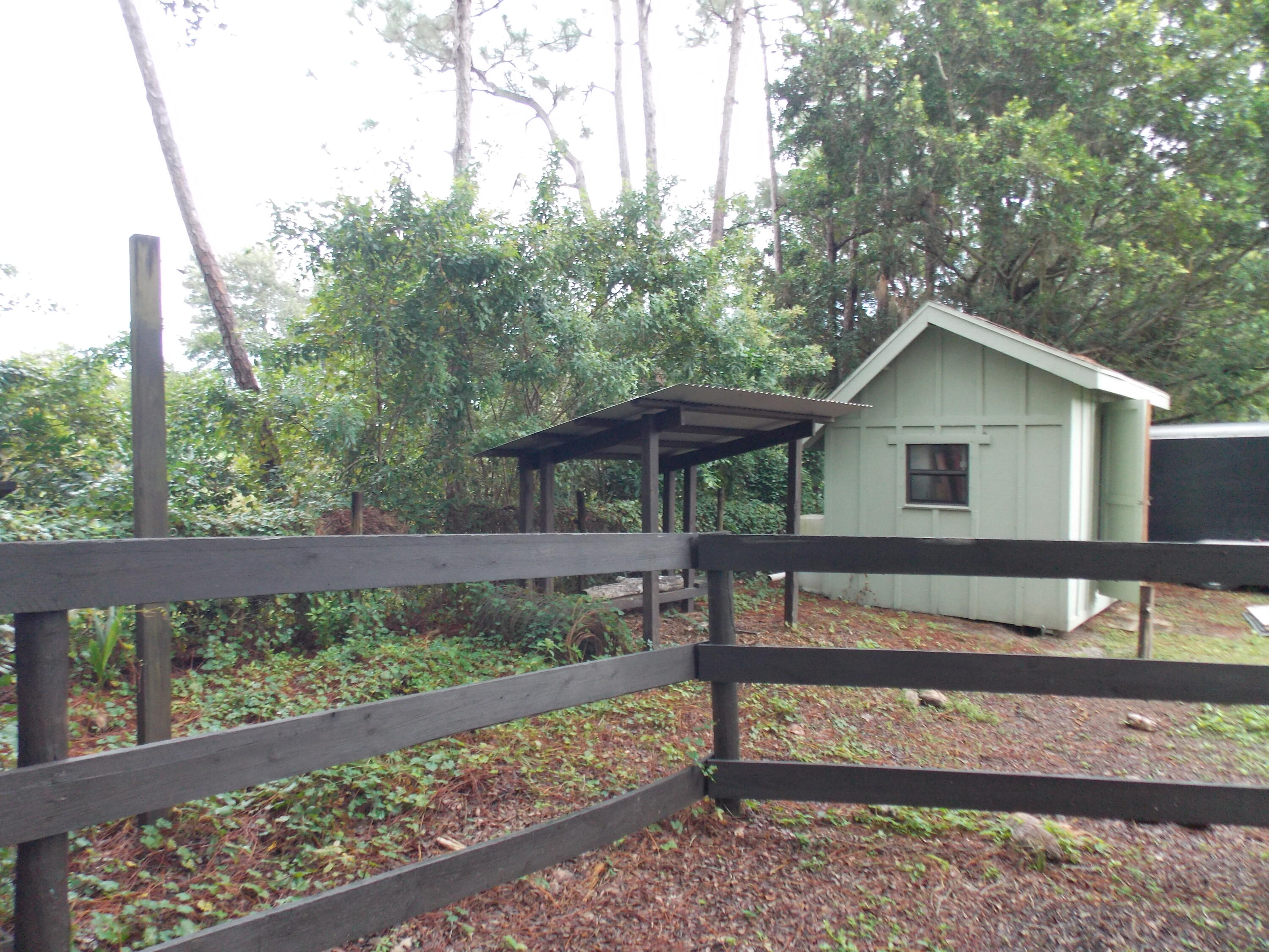 16219 134th Terrace North Jupiter, FL 33478 - Photo 38 of 40 a view of a house with a yard and wooden fence