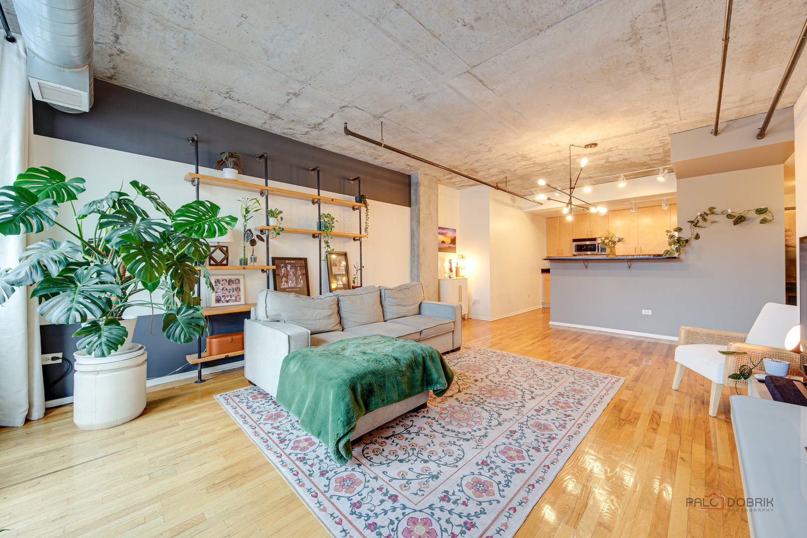 700 West Van Buren Street, Unit 1402 Chicago, IL 60607 - Photo 6 of 15 a living room with furniture and a potted plant