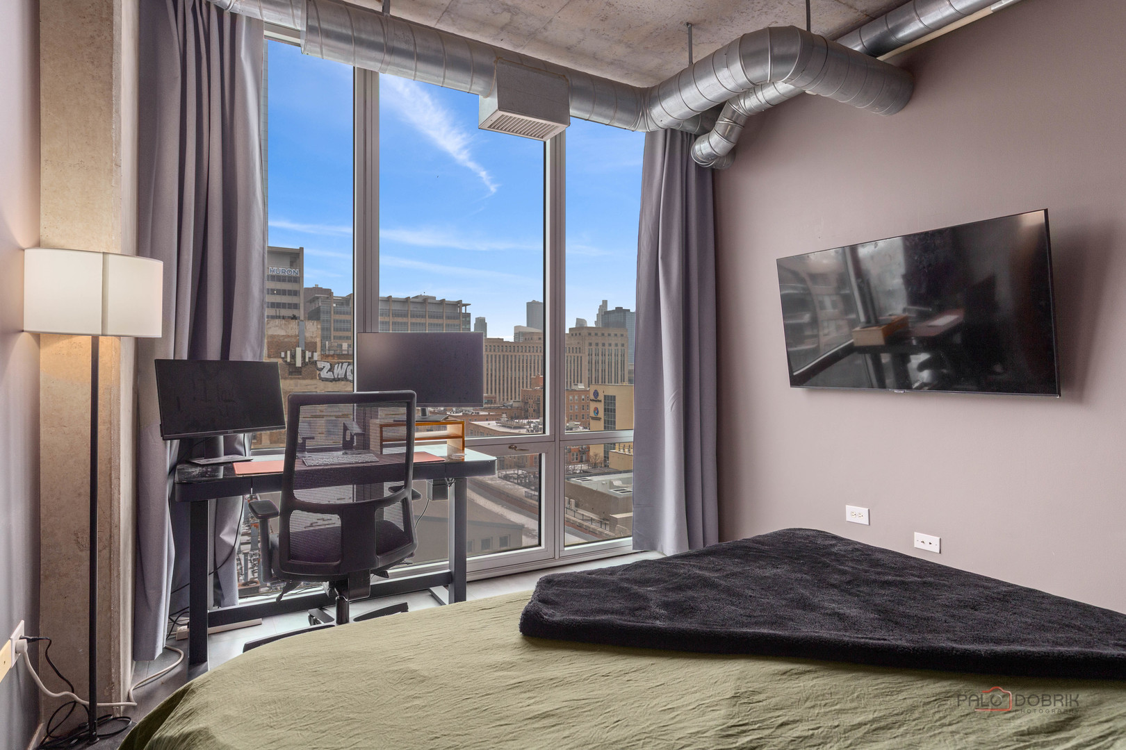 700 West Van Buren Street, Unit 1402 Chicago, IL 60607 - Photo 10 of 15 a living room with a bed furniture and a flat screen tv