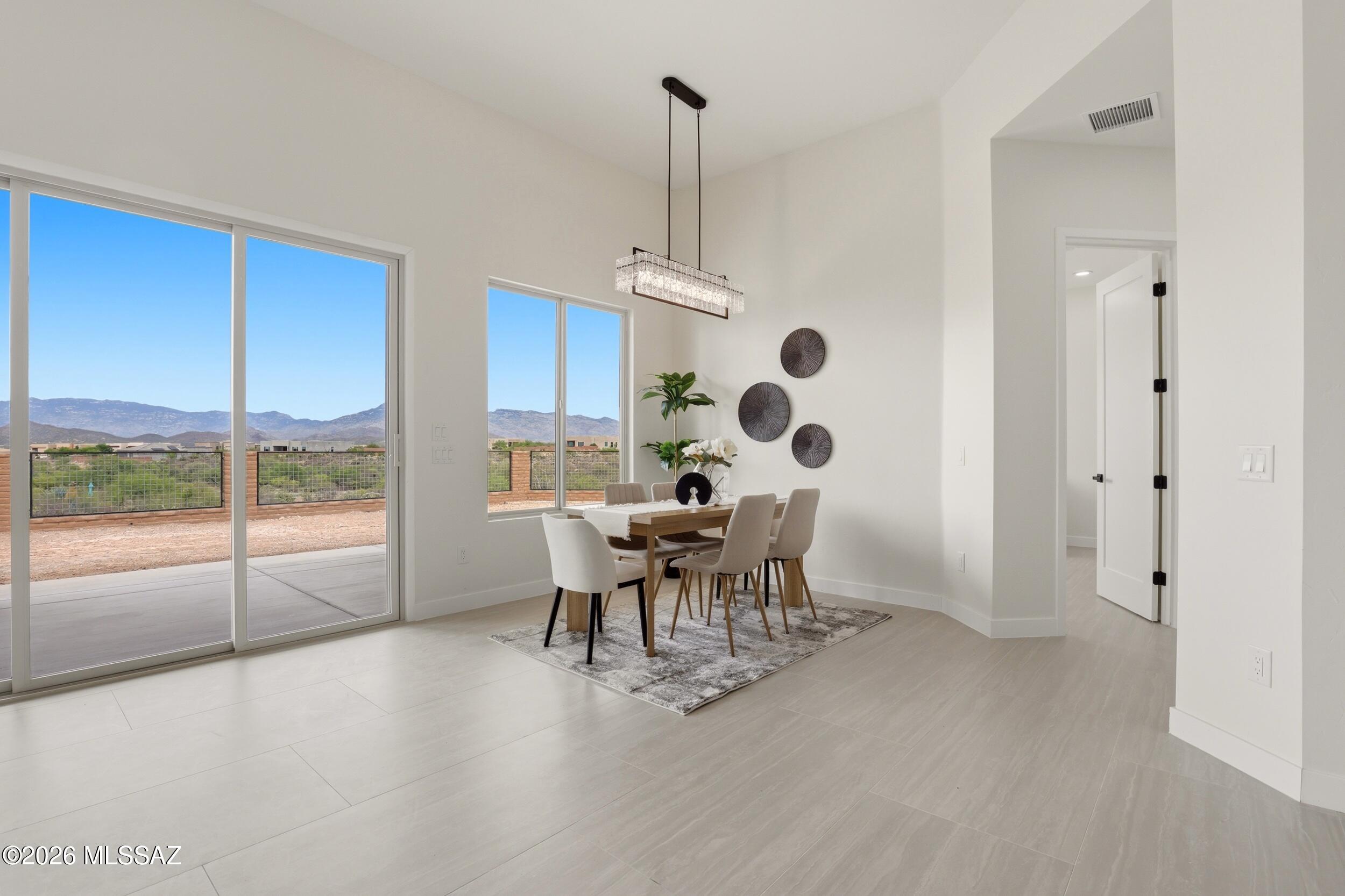 14527 East Sands Ranch Road Vail, AZ 85641 - Photo 17 of 48 a dining room with furniture a chandelier and a large window