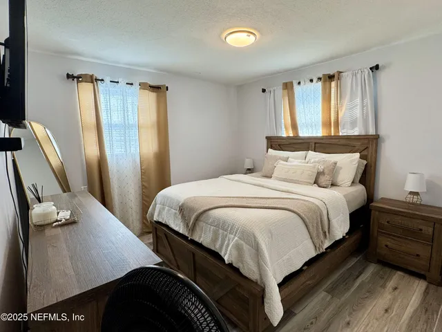 a bedroom with a bed and a chandelier