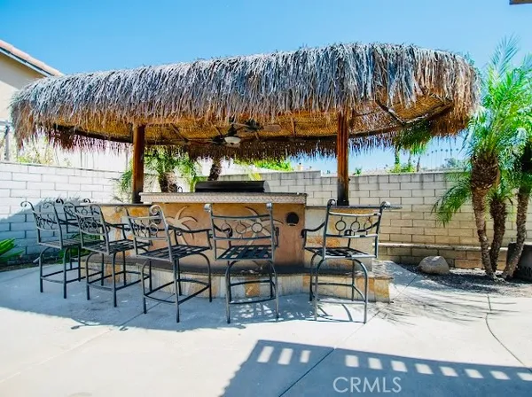 a view of a patio with table and chairs with wooden floor