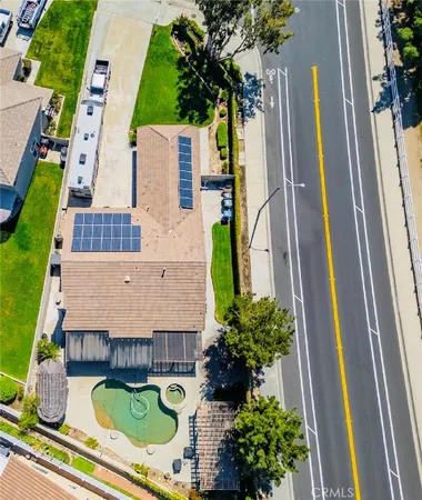 an aerial view of a house with swimming pool garden and patio